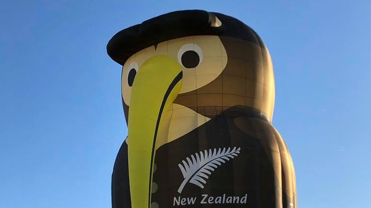 A hot air balloon in the shape of a kiwi bird dressed in black with New Zealand and a silver fern emblazoned on it.