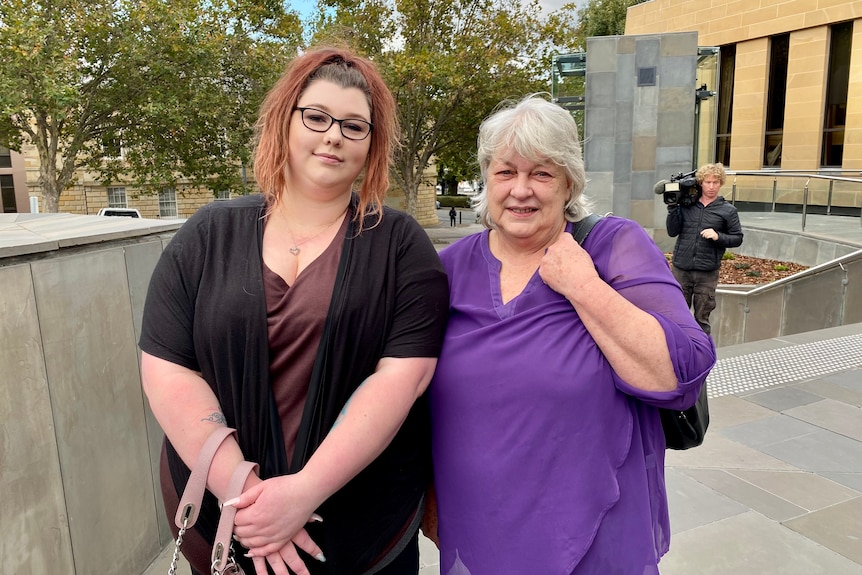 Two women stand in front of the steps at Hobart's Supreme Court.