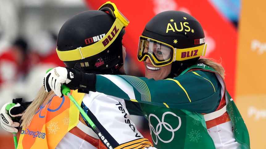 Australia's Sami Kennedy-Sim embraces Sweden's Lisa Andersson after a women's ski cross quarterfinal