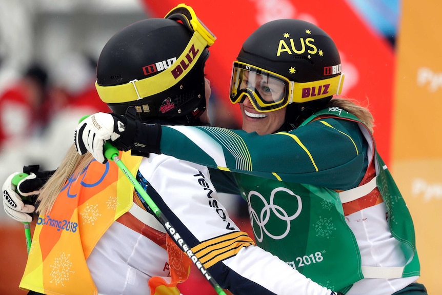Australia's Sami Kennedy-Sim embraces Sweden's Lisa Andersson after a women's ski cross quarterfinal