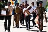 Sri Lankan police carrying ballot boxes