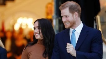 Prince Harry and Meghan smile.