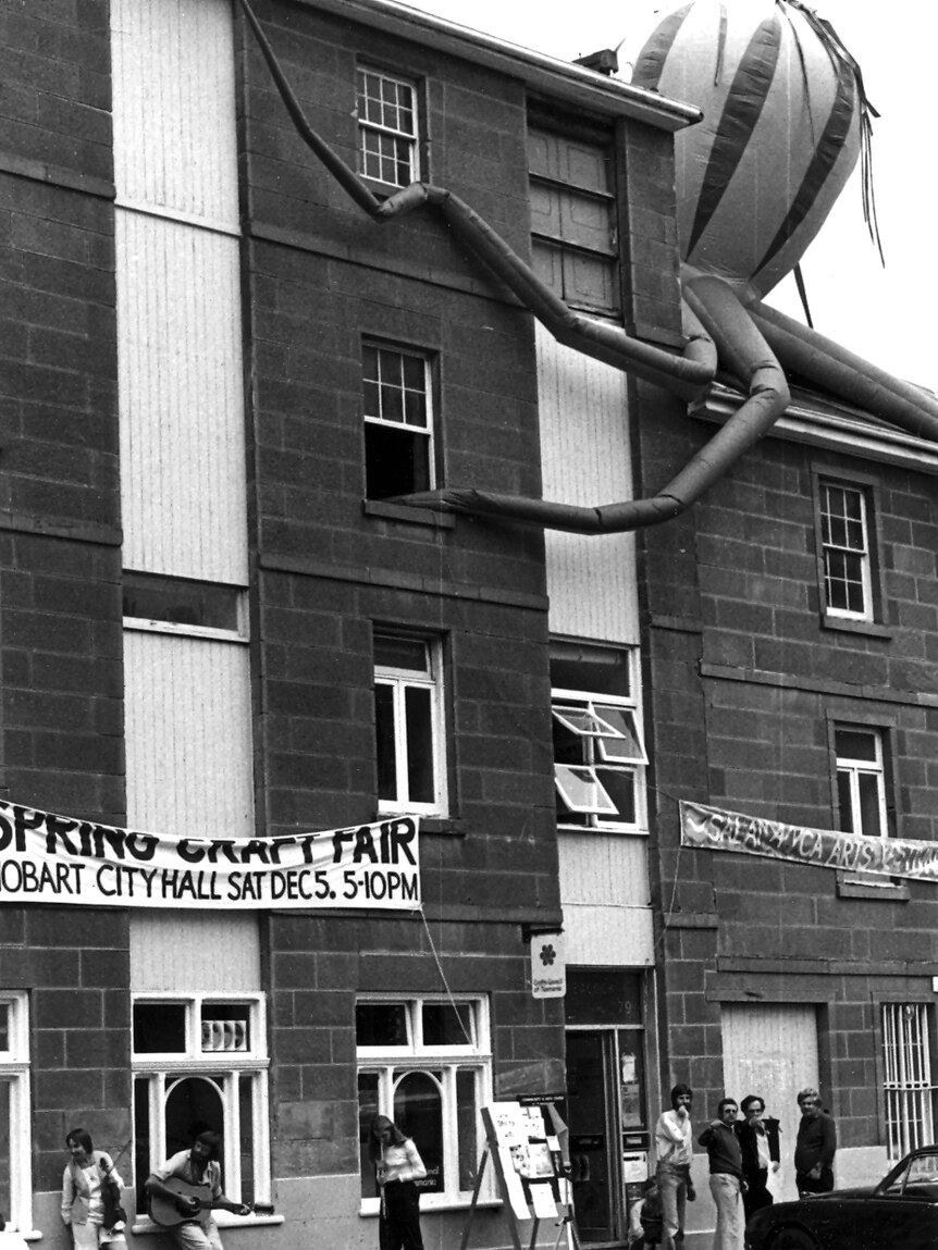 Black and white image of the Salamanca Arts Centre building with a large, inflated octopus sculpture