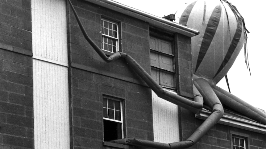 Black and white image of the Salamanca Arts Centre building with a large, inflated octopus sculpture