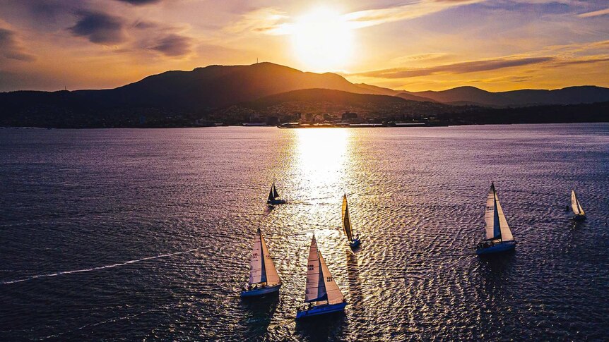 Sunset over Hobart's Mount Wellington / Kunanyi with sailboats on the Derwent.