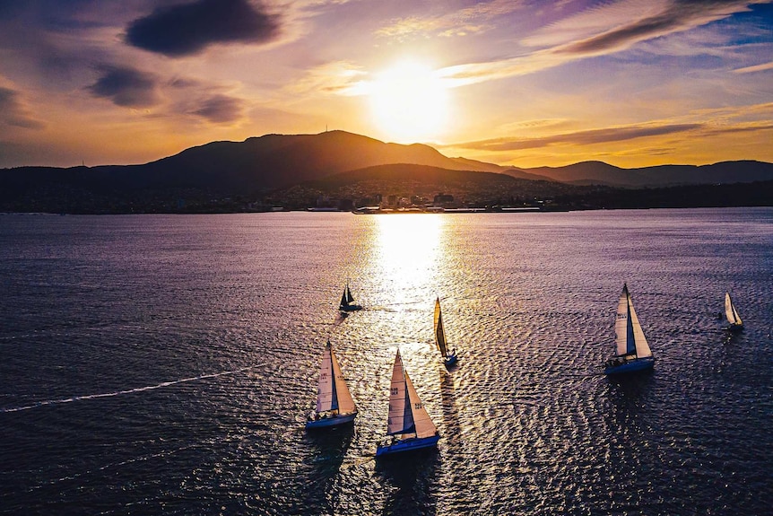 Sunset over Hobart's Mount Wellington/kunanyi with sailboats on the Derwent.