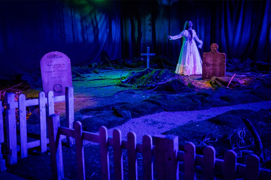 Colour photo of Bobbie-Jean Henning as bloody bride standing in graveyard scene in immersive theatre production A Midnight Visit