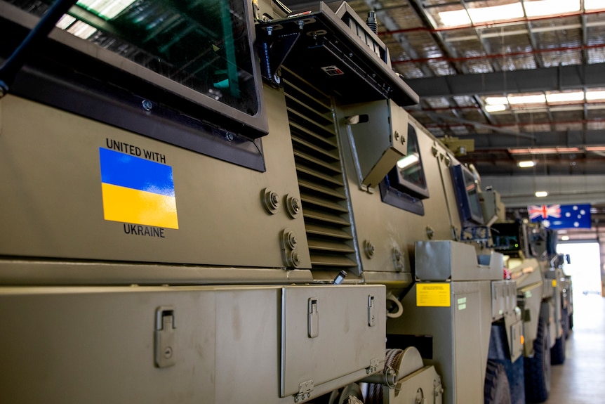 Two armoured vehicles appear with Ukrainian flags on the side