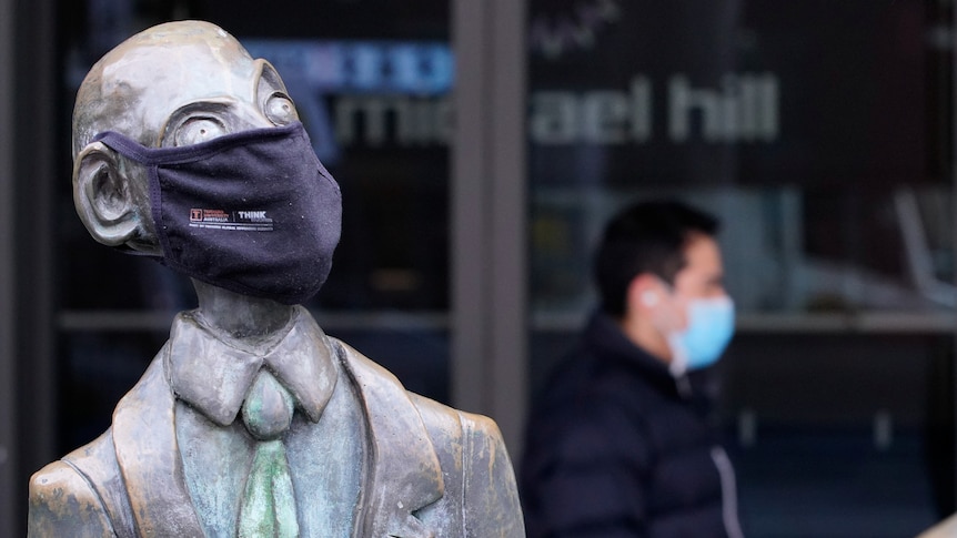A statue wearing a face mask in Melbourne city