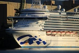 A picture of a huge cruise ship — the infamous Ruby Princess — at what looks like an industrial dock.