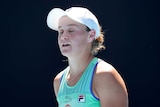 Ash Barty is wearing a white hat, eyes closed a look of resignation on her face.