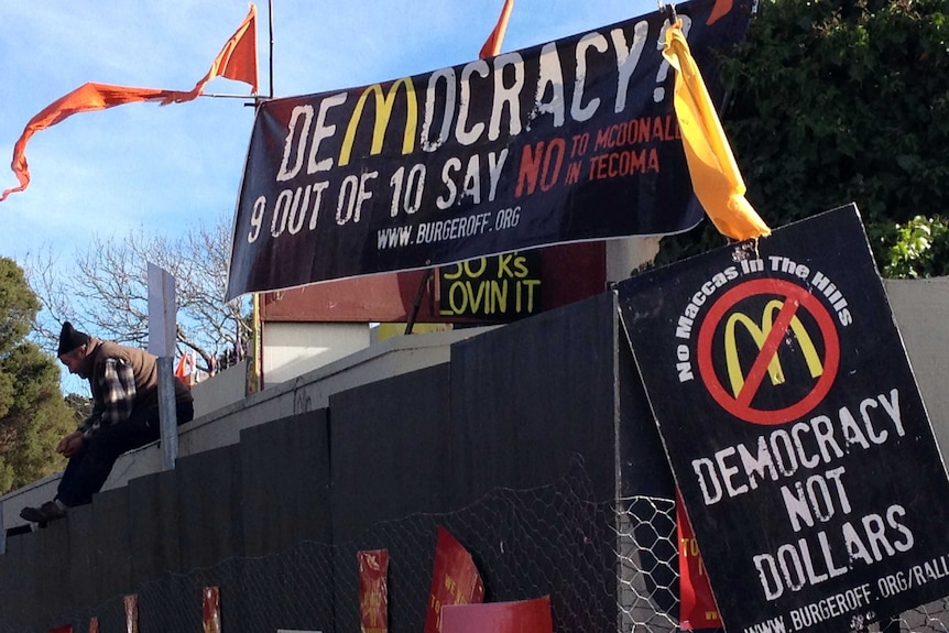 A protester on the roof of the McDonalds being built at Tecoma