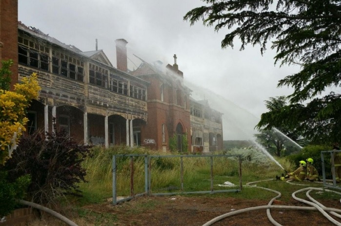 Firefighters extinguish the historic building in Goulburn.