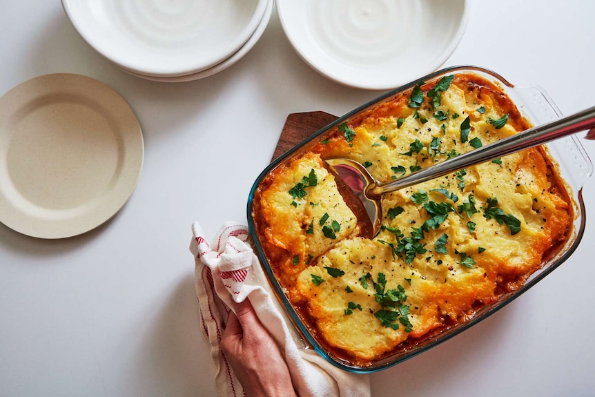 A large tray of beef cottage pie fresh from the oven, ready to be served for a family dinner.