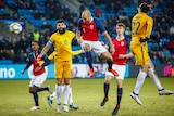 Tore Reginiussen of Norway heads in Norway's second goal with Australia's Jackson Irvine.
