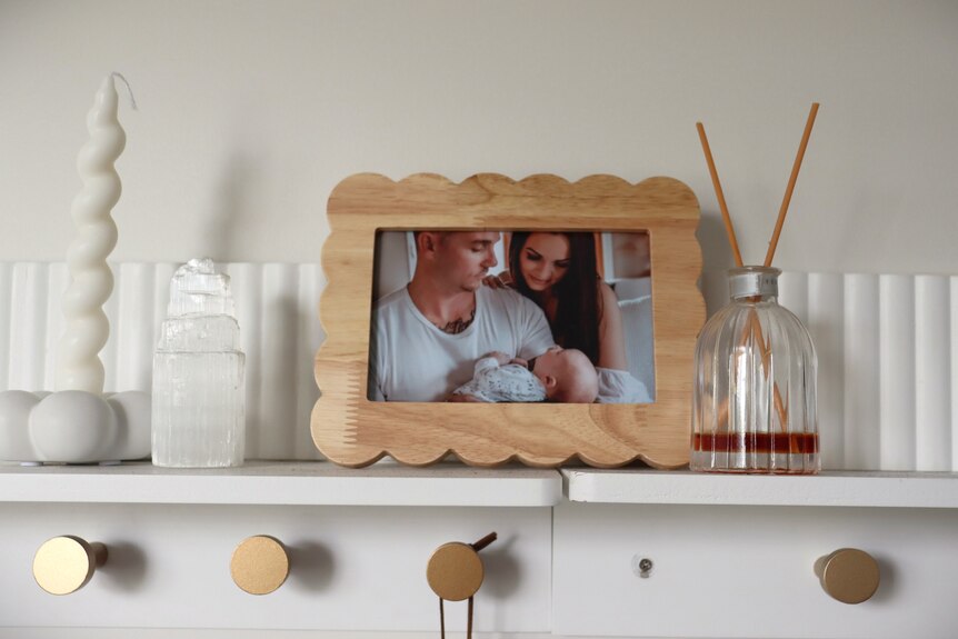 picture frame family photo next to candles