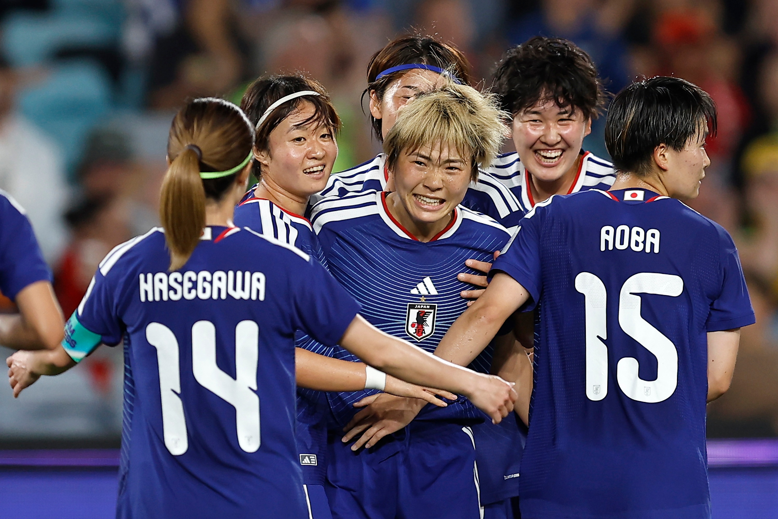 Japan women's footballers celebrate a goal