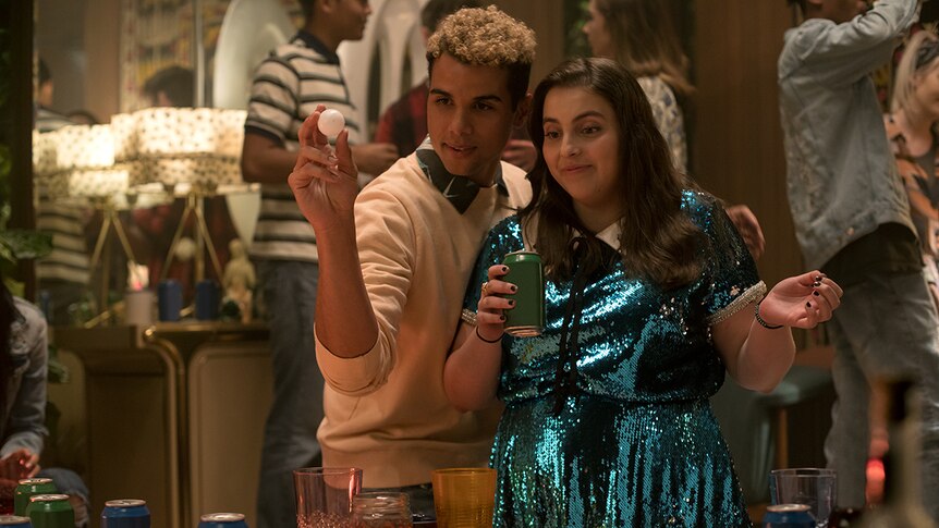 Colour film still of Mason Gooding and Beanie Feldstein at a house party in 2019 film Booksmart.