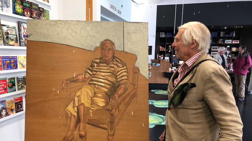 Victor Caulfield admires his portrait, painted by Warrnambool artist Gareth Colliton.