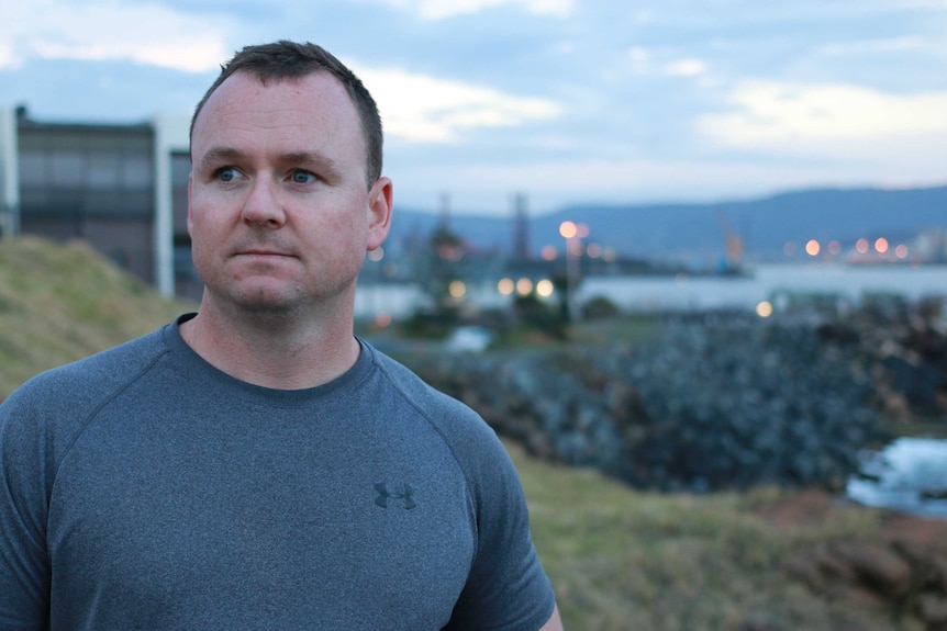 A man looks contemplative looking out to distance.