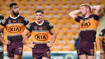 Brisbane Broncos Darius Boyd, Payne Haas, Corey Paix and Tom Flegler stand in the in-goal after another Roosters try.