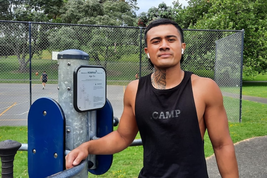 Quest Haerewa stands in an outdoor gym wearing a black training top. 