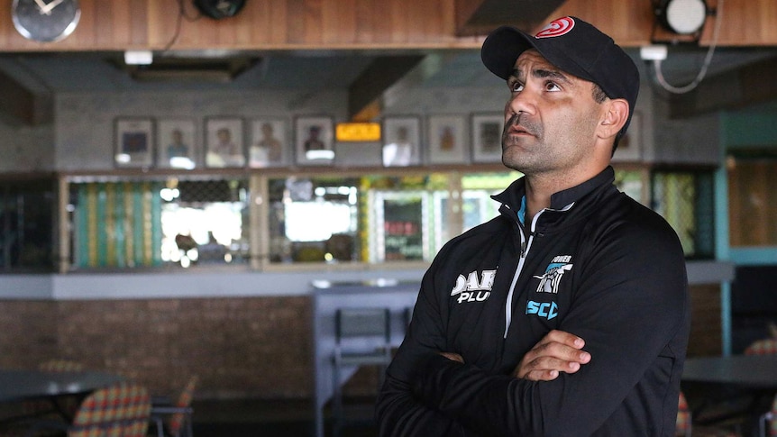 Lindsay Thomas stands in the Mallee Park clubrooms, looking up at the premiership flags that line the walls