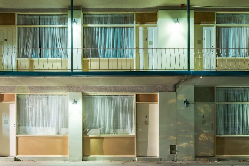 The front doors and windows of a budget motel.