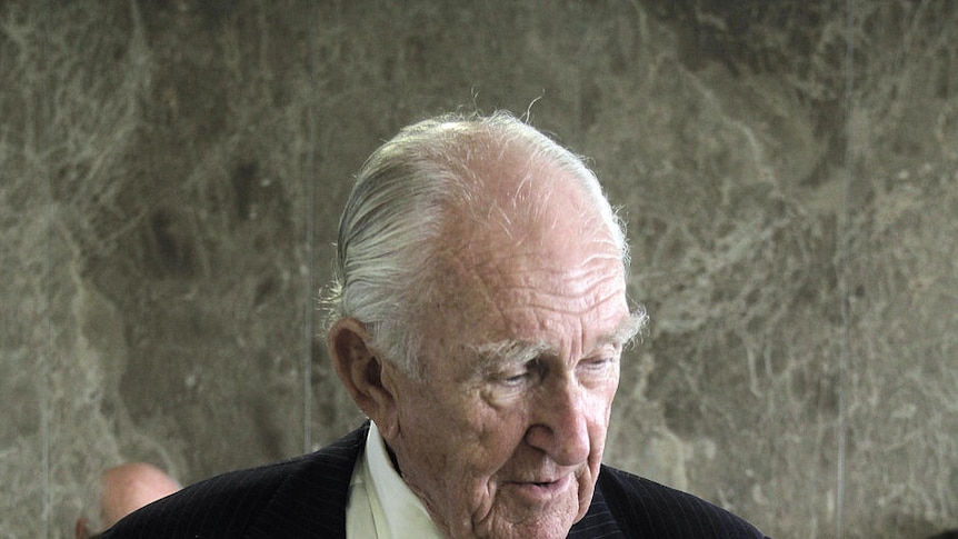 Malcolm Fraser signs a copy of his autobiography