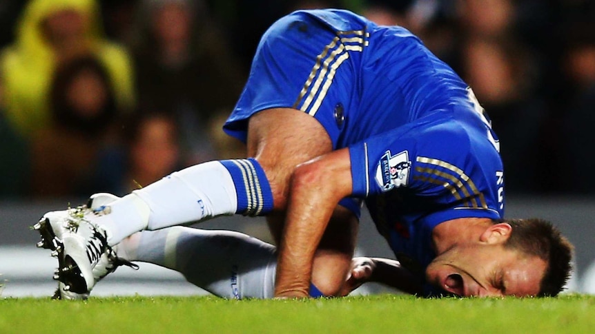 John Terry was injured in a collision with Liverpool's Luis Suarez on his Premier League comeback.