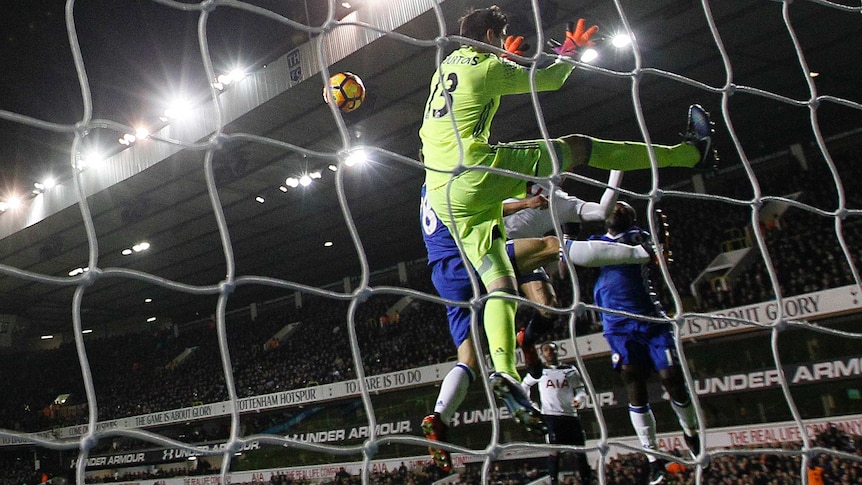 Spurs' Dele Alli (hidden), scores past Chelsea keeper Thibaut Courtois in the Premier League.