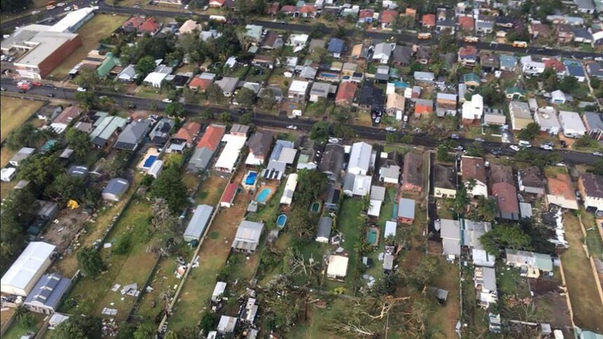 A helicopter view of rubbish strewn through the yards of damaged houses.