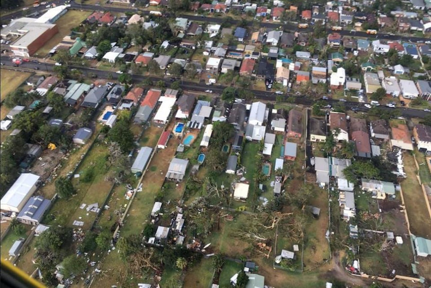 A helicopter view of rubbish strewn through the yards of damaged houses.