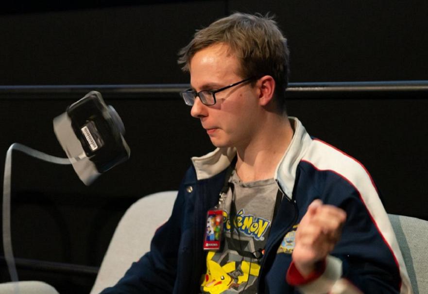 A man flipping a Nintendo DS