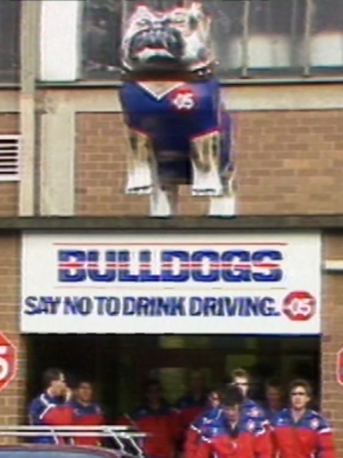 A large bulldog statue above a door.
