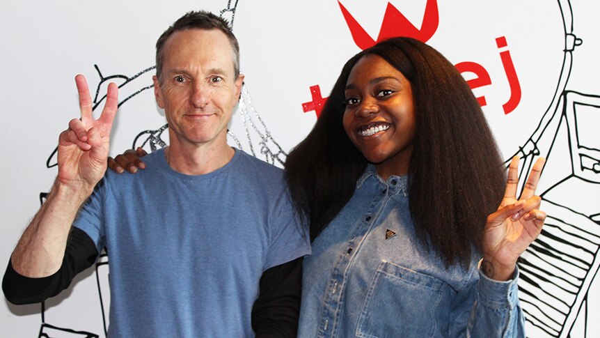 Photograph of Richard Kingsmill and Noname standing infront of a triple j logo.