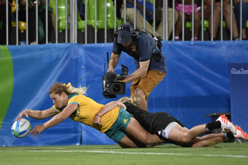 Australia's Emma Tonegato scores a try in the women’s rugby sevens gold medal match