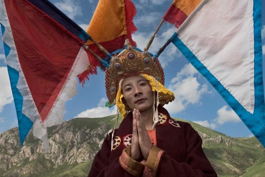 A Tibetan monk in traditional dress at an annual riding festival.