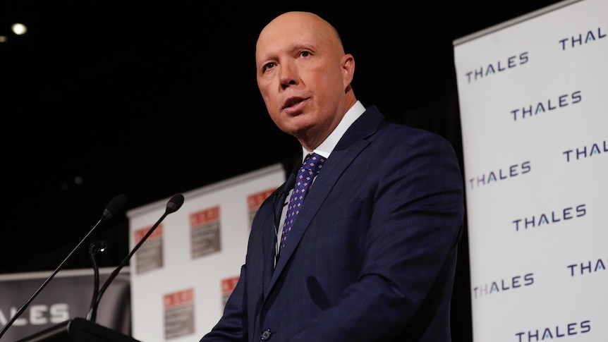 Peter Dutton speaks at a lecturn in front of a Thales defence banner