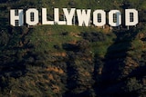 The white Hollywood sign with greenery in the background.