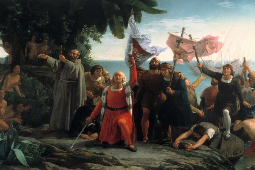 A classical painting shows a dramatic scene of Spanish colonisers carrying swords and crosses as they land on a foreign coast.