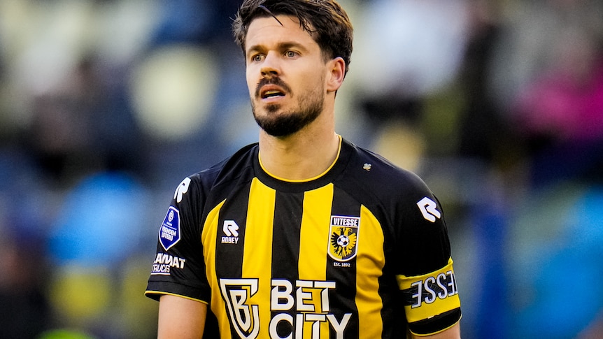 Football player Marco van Ginkel, photographed during a match, wearing a striped jersey