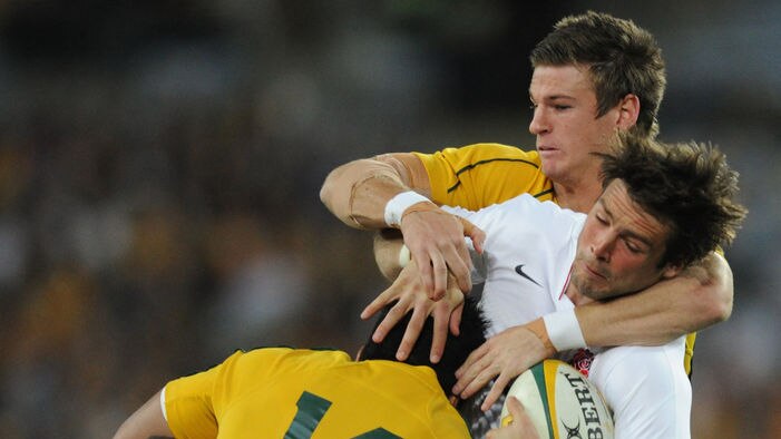 Upset win: England's Ben Fodem is tackled by Australia's Rob Horne and Digby Ioane.