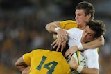 Upset win: England's Ben Fodem is tackled by Australia's Rob Horne and Digby Ioane.