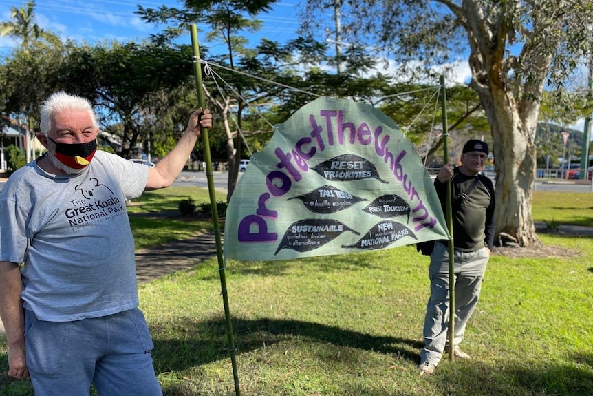 Protesters hold a sign calling for unburnt koala habitat to be saved