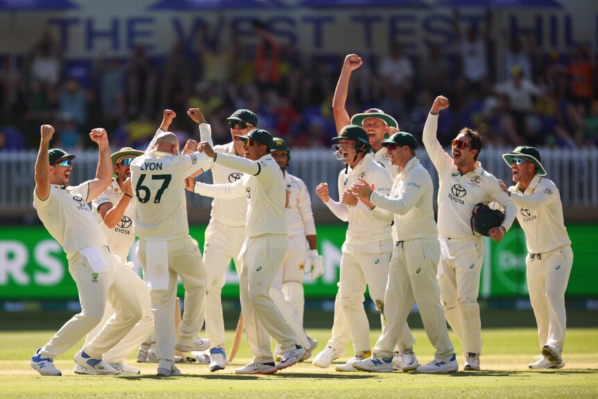 The Australian team celebrate in unison as Nathan Lyon is awarded his 500th Test wicket