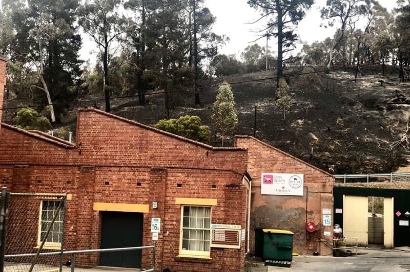 The Udder Delights cheese factory at Lobethal with a blackened hill in the background.