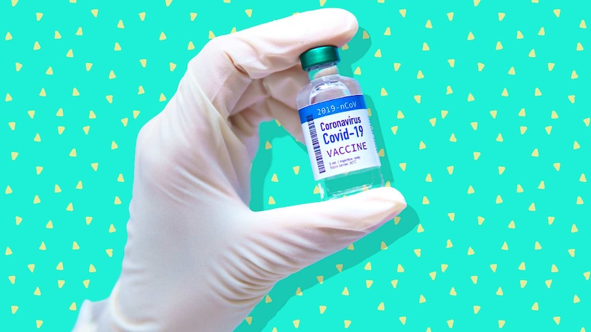 Gloved hand holding a vial which says COVID-19 Vaccine.