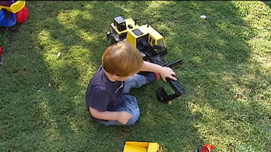 A foster child sits on the floor