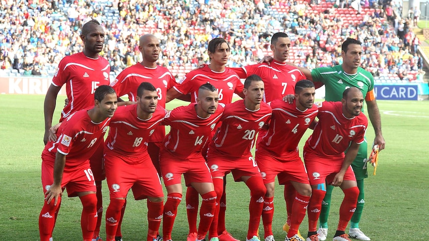 The Palestinian soccer team lines up for a photo at the Asian Cup.